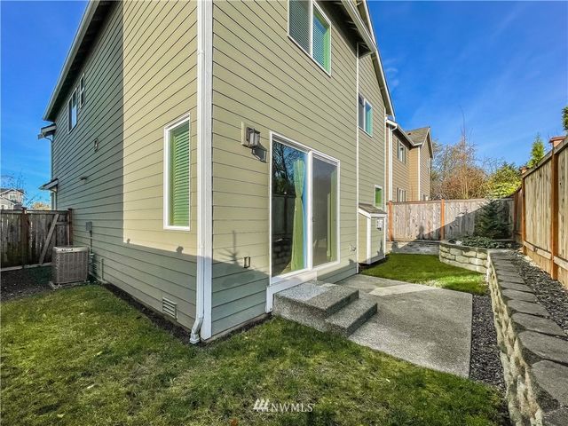 a backyard of a house with garden and barbeque oven