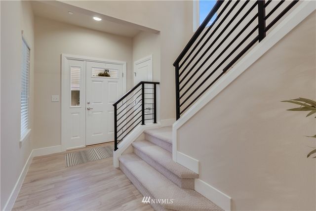 a view of entryway and hall with wooden floor