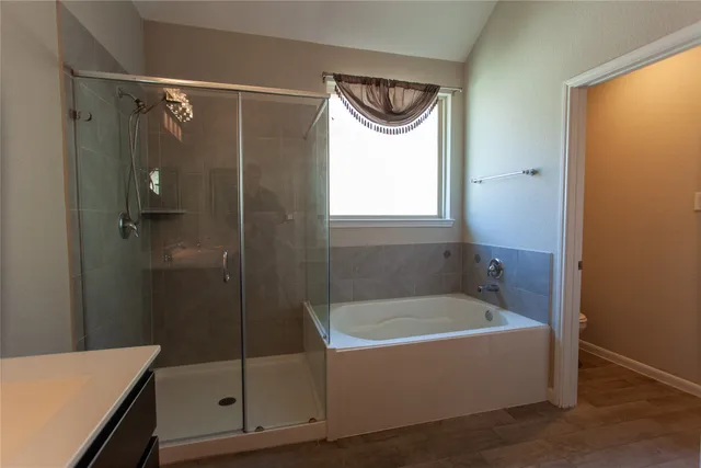 a bathroom with a bathtub a shower and a sink