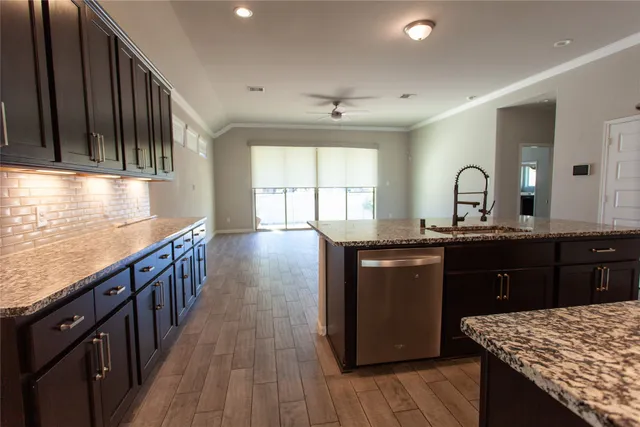 a kitchen with granite countertop lots of counter top space and stainless steel appliances