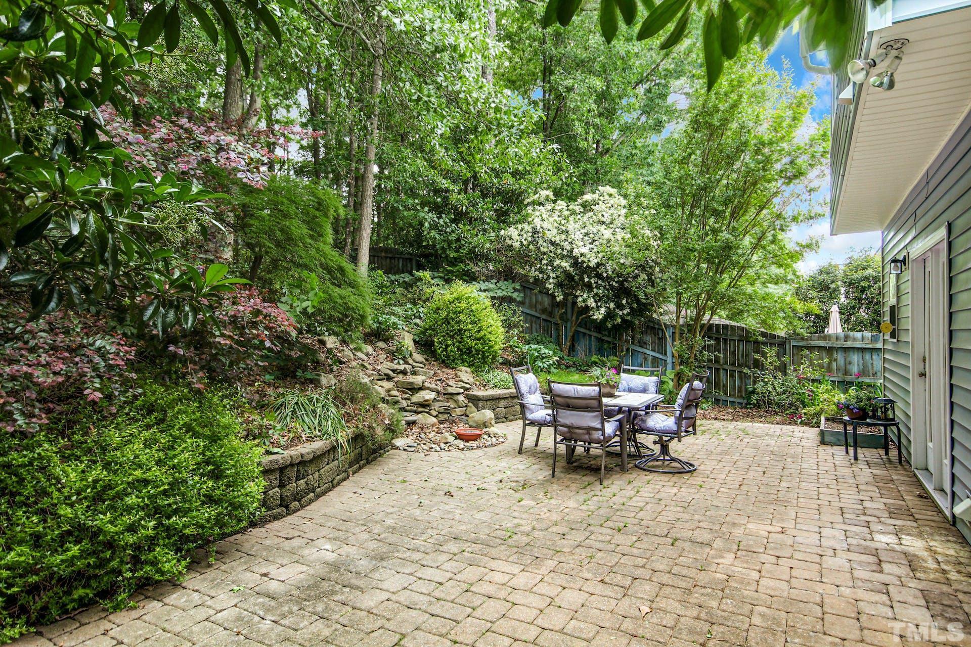 5852 Wynmore Road Raleigh, NC 27610 - Photo 23 of 25 a view of a patio with table and chairs and potted plants