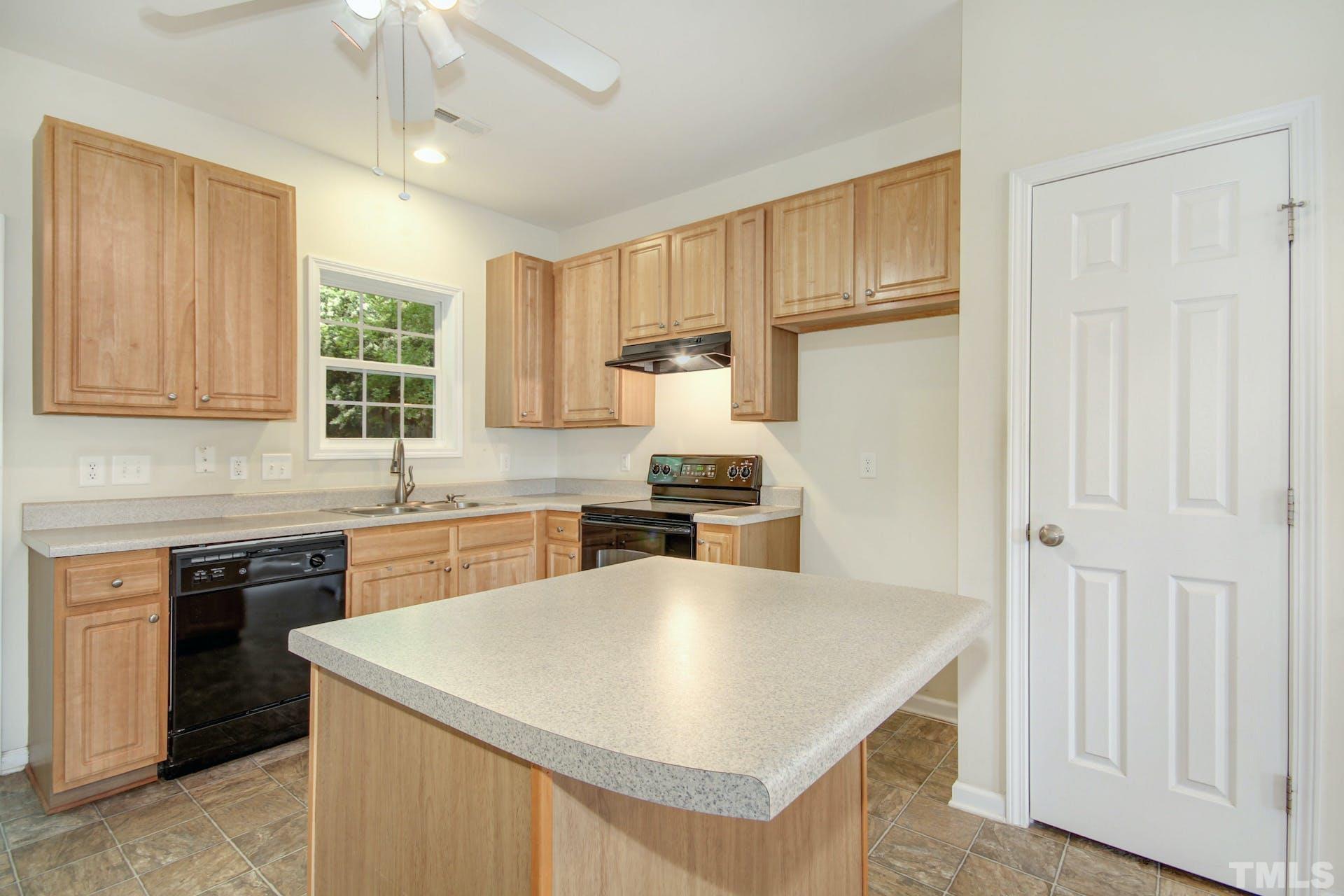 5852 Wynmore Road Raleigh, NC 27610 - Photo 8 of 25 a kitchen with stainless steel appliances granite countertop a stove a sink dishwasher and a refrigerator