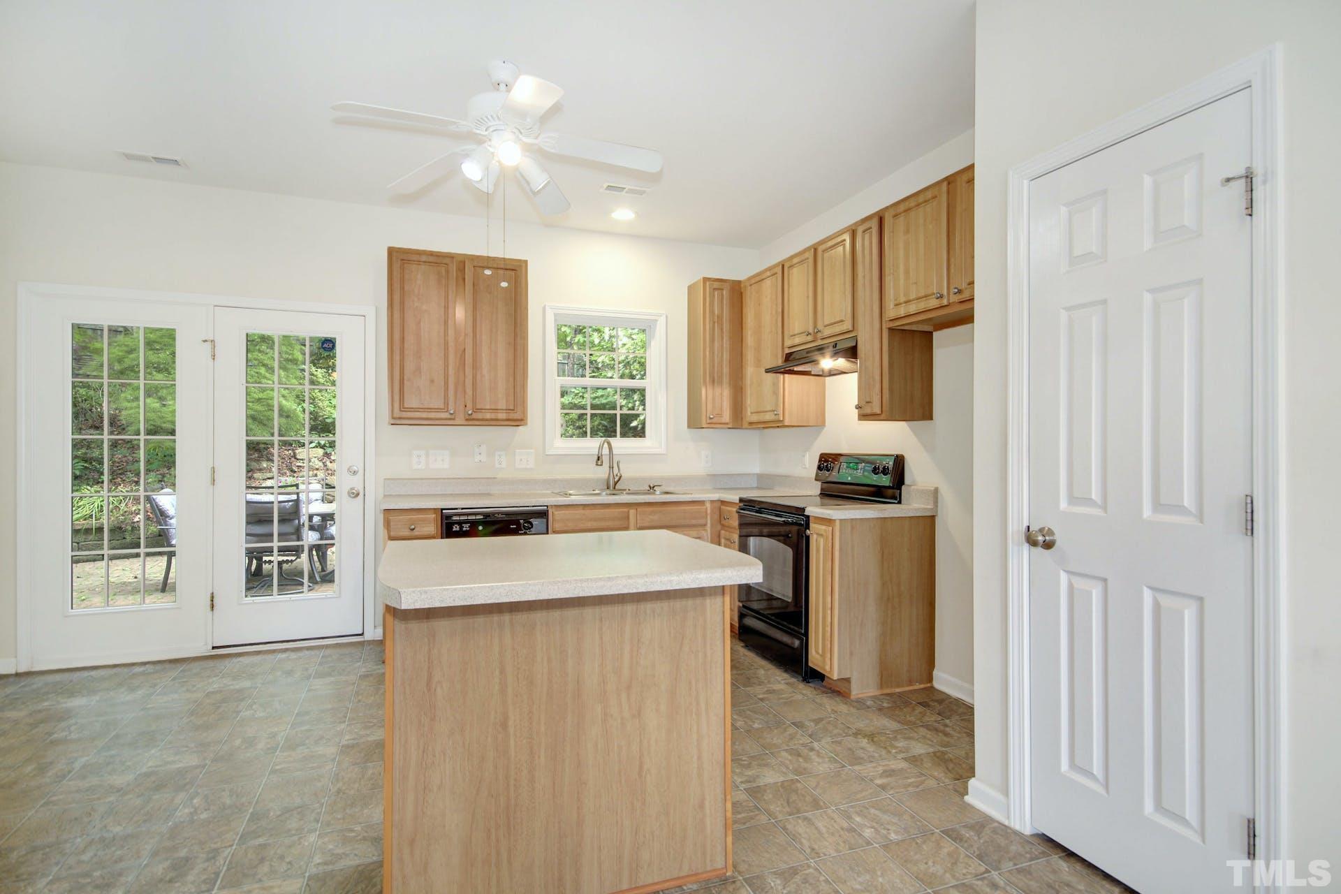 5852 Wynmore Road Raleigh, NC 27610 - Photo 9 of 25 a kitchen with a stove a sink and a refrigerator
