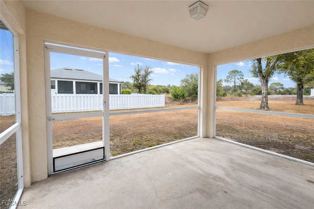 3215 13th Street Southwest Lehigh Acres, FL 33976 - Photo 2 of 12 an empty room with sliding glass door and mountain view