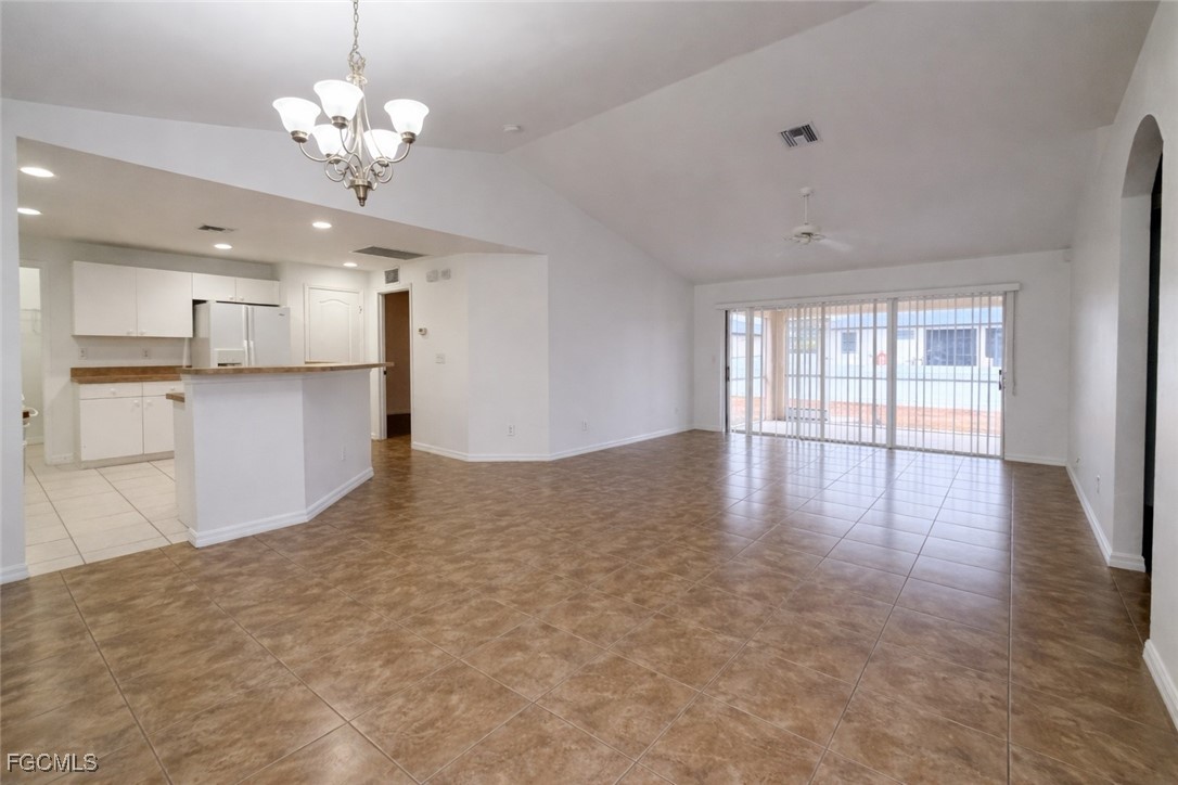 3215 13th Street Southwest Lehigh Acres, FL 33976 - Photo 3 of 12 a view of a kitchen with a sink and chandelier