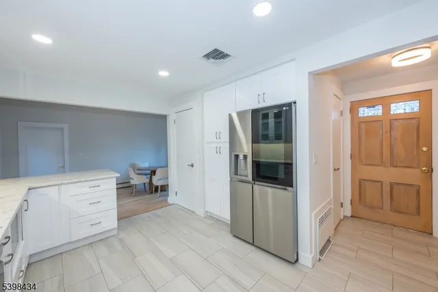 a room with a dresser and mirror