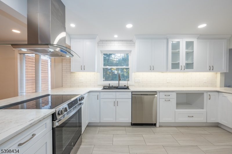 7 Oak Tree Lane Little Falls, NJ 07424 - Photo 15 of 46 a kitchen with granite countertop a sink stove and cabinets