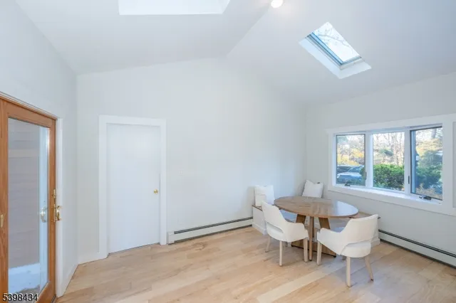 a view of a room with a table and chairs