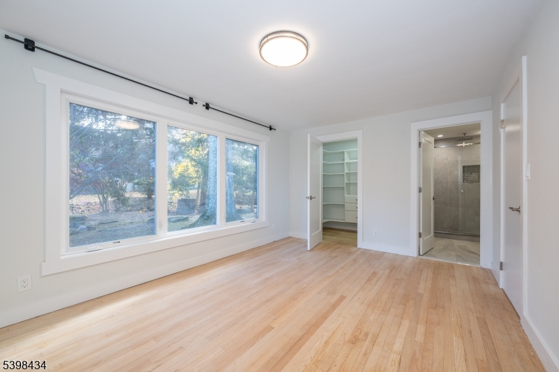 7 Oak Tree Lane Little Falls, NJ 07424 - Photo 21 of 46 an empty room with wooden floor and windows