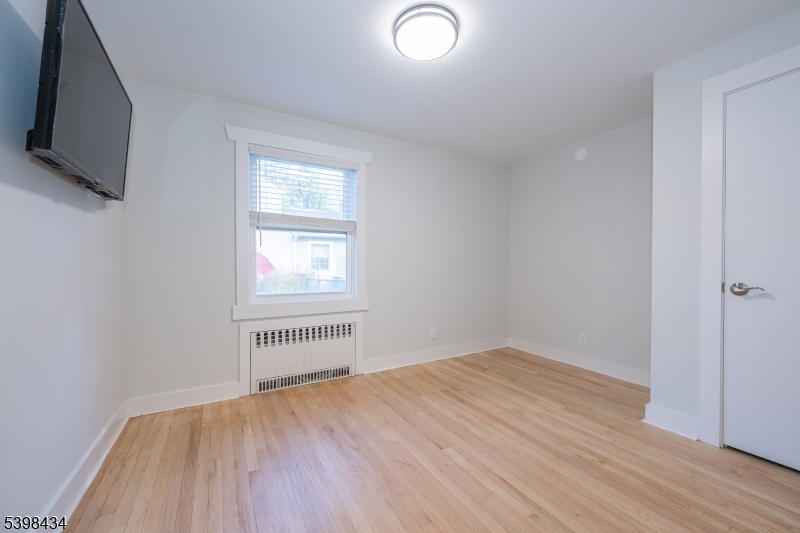 7 Oak Tree Lane Little Falls, NJ 07424 - Photo 25 of 46 a view of empty room with wooden floor and fan