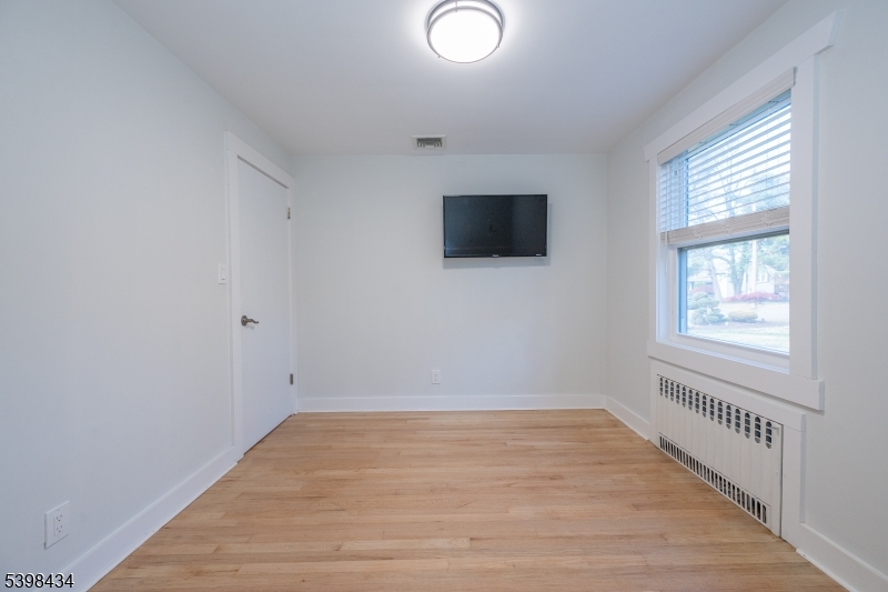 7 Oak Tree Lane Little Falls, NJ 07424 - Photo 26 of 46 wooden floor in an empty room with a window