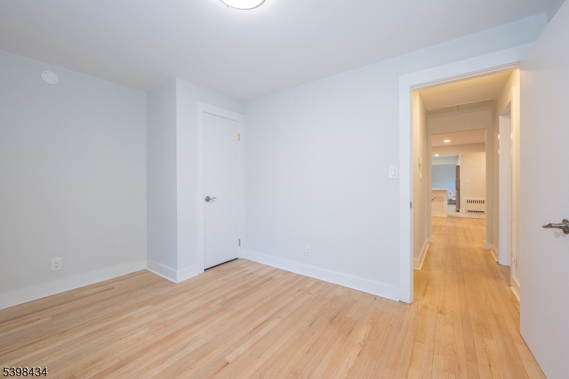 7 Oak Tree Lane Little Falls, NJ 07424 - Photo 27 of 46 a view of a room with wooden floor and a bathroom