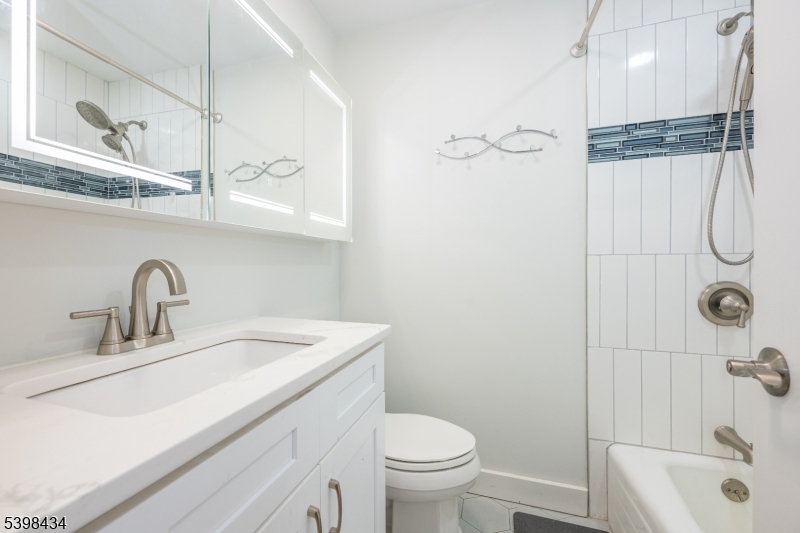 7 Oak Tree Lane Little Falls, NJ 07424 - Photo 30 of 46 a bathroom with a sink a toilet and shower