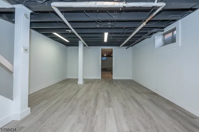 a view of hallway with wooden floor