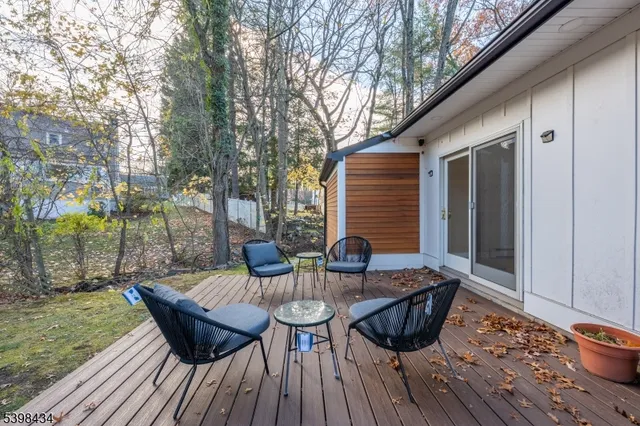 a view of a roof deck with furniture