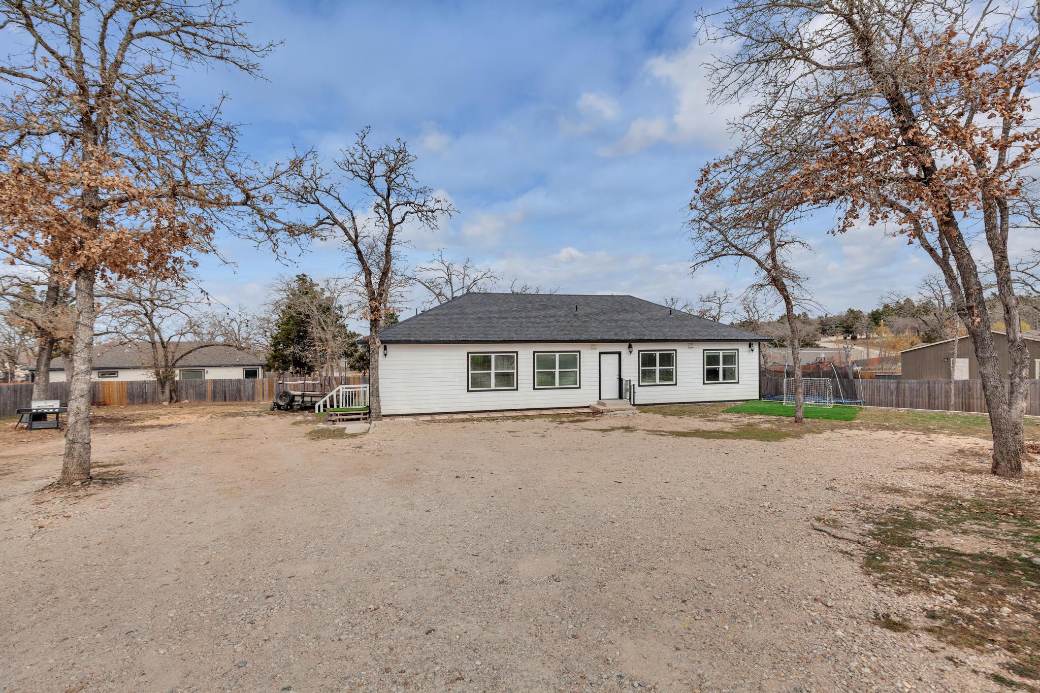 114 Crepe Myrtle Parkway Elgin, TX 78621 - Photo 31 of 40 Back of property featuring roof with shingles
