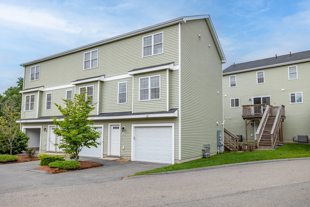 311 Littleton Road, Unit 20 Chelmsford, MA 01824 - Photo 1 of 35 a front view of house with outdoor seating and trees