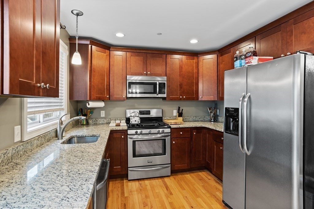 311 Littleton Road, Unit 20 Chelmsford, MA 01824 - Photo 11 of 35 a kitchen with granite countertop stainless steel appliances cabinets a sink and a counter space