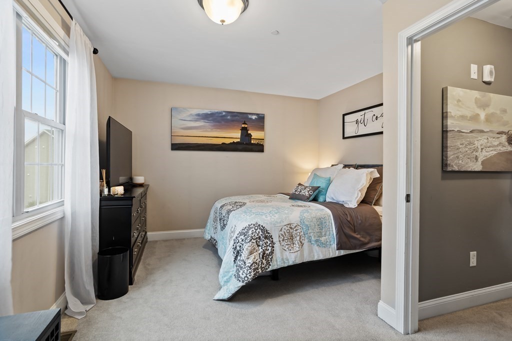311 Littleton Road, Unit 20 Chelmsford, MA 01824 - Photo 17 of 35 a bedroom with a bed and a refrigerator