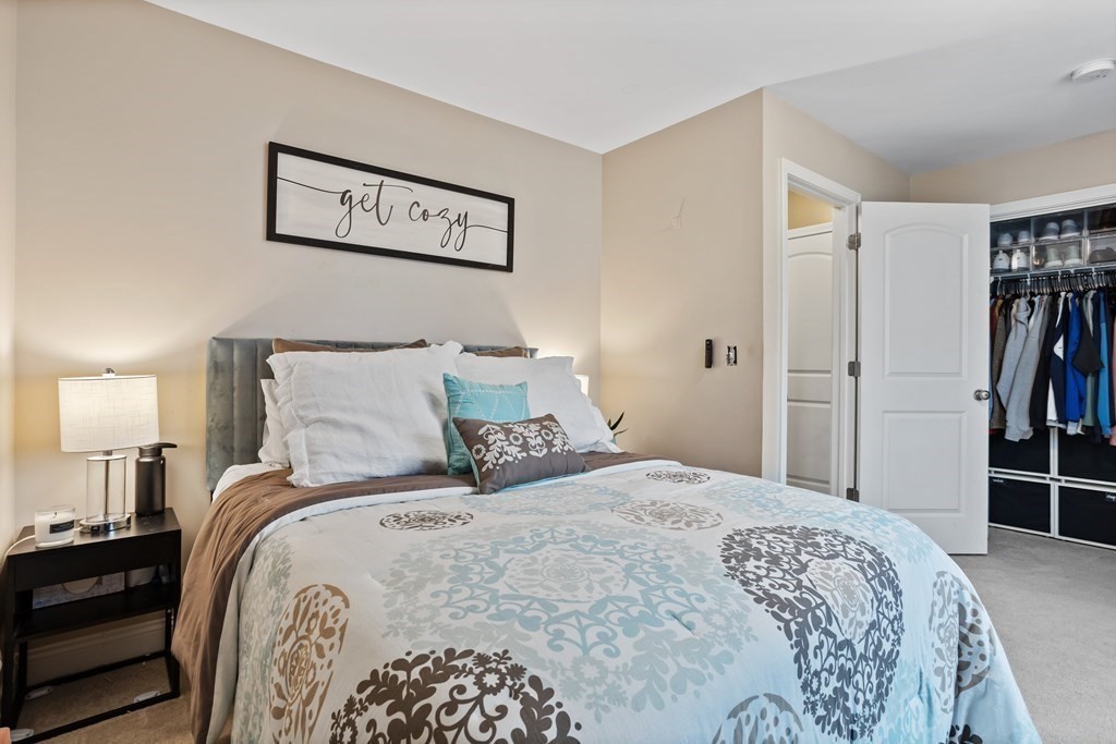 311 Littleton Road, Unit 20 Chelmsford, MA 01824 - Photo 18 of 35 a bedroom with a bed and a walk in closet