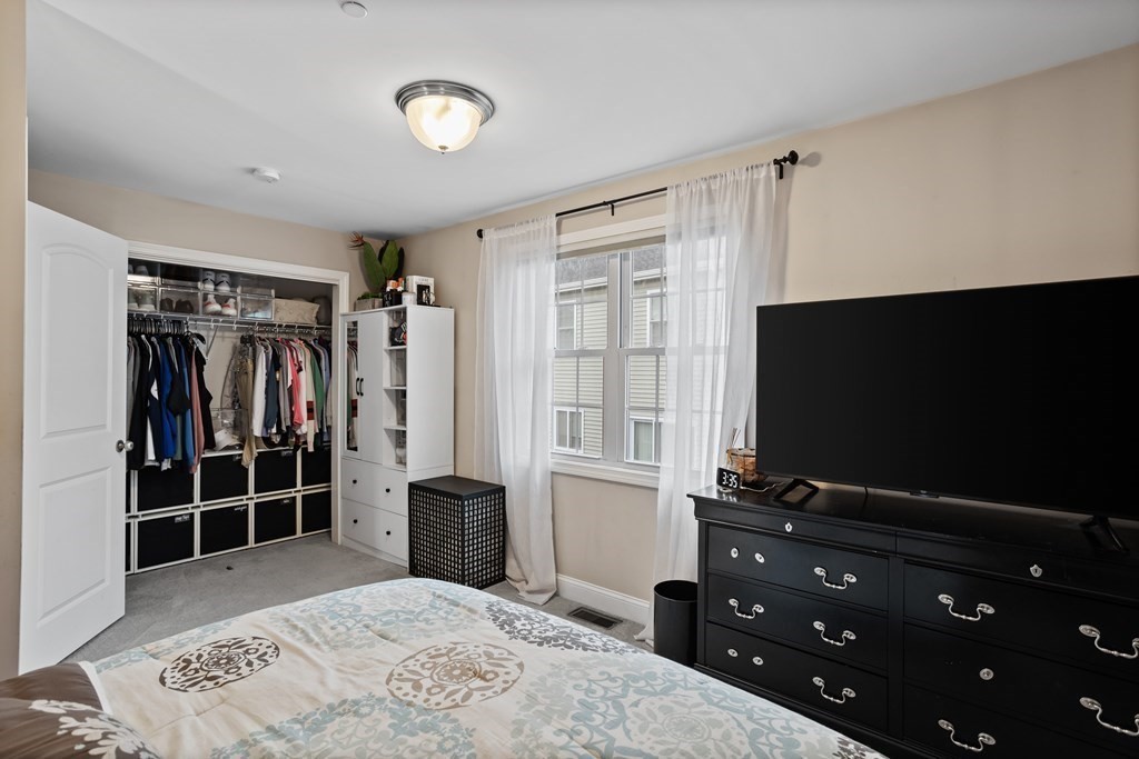 311 Littleton Road, Unit 20 Chelmsford, MA 01824 - Photo 20 of 35 a bedroom with a bed and a flat screen tv