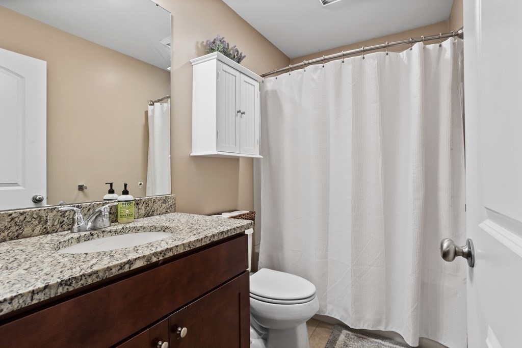 311 Littleton Road, Unit 20 Chelmsford, MA 01824 - Photo 21 of 35 a bathroom with a granite countertop sink and a mirror