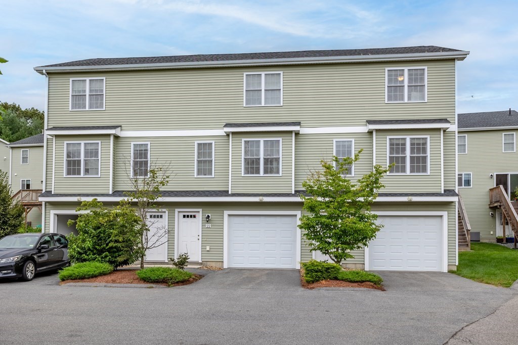 311 Littleton Road, Unit 20 Chelmsford, MA 01824 - Photo 33 of 35 a front view of a house with a yard and garage