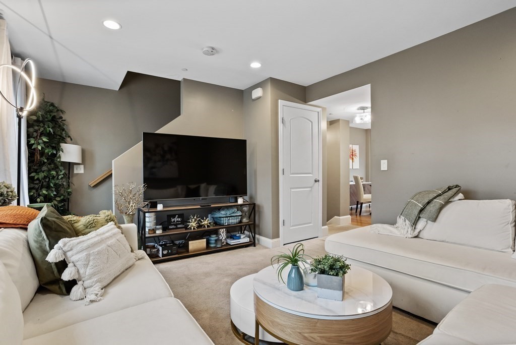 311 Littleton Road, Unit 20 Chelmsford, MA 01824 - Photo 5 of 35 a living room with furniture and a flat screen tv