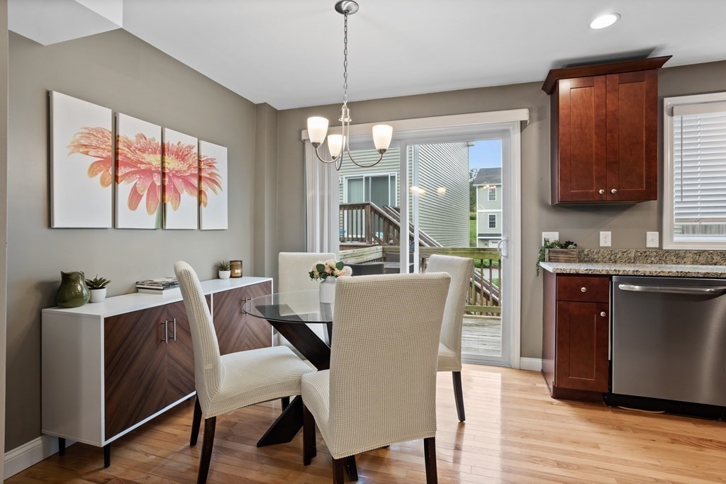 311 Littleton Road, Unit 20 Chelmsford, MA 01824 - Photo 7 of 35 a dining room with furniture a chandelier and wooden floor