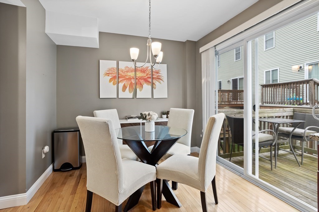 311 Littleton Road, Unit 20 Chelmsford, MA 01824 - Photo 8 of 35 a view of a dining room with furniture wooden floor and chandelier