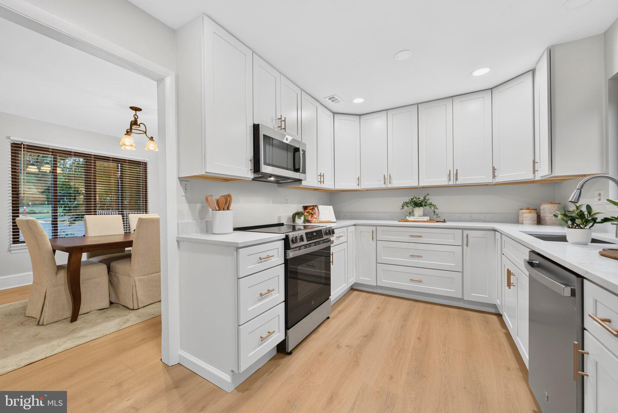 1427 Green Run Lane Reston, VA 20190 - Photo 17 of 44 New LVP floor - foyer, kitchen, hallway, DR