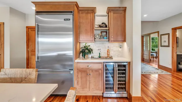 a kitchen with cabinets and wooden floor