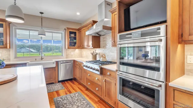 a kitchen with stainless steel appliances granite countertop a stove and a sink