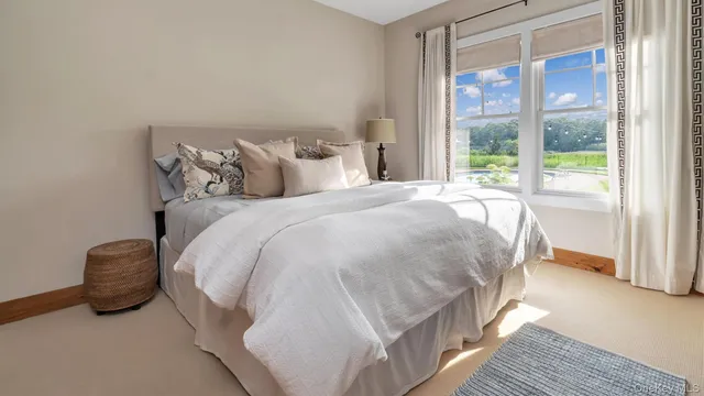 a bed sitting in a bedroom next to a window
