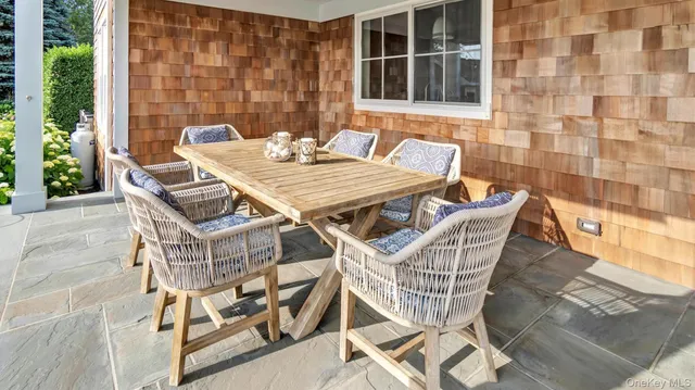 a patio with table and chairs