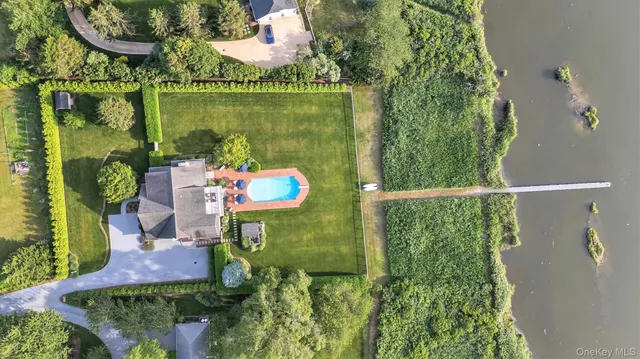 an outdoor sitting area with a lake view