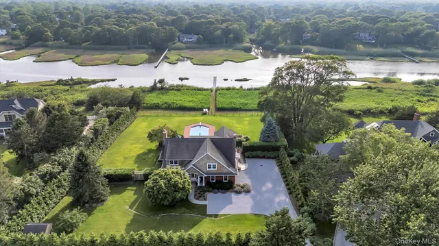 an aerial view of house with yard swimming pool and outdoor seating