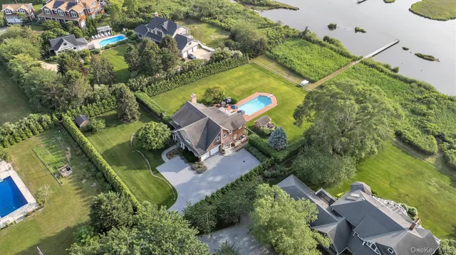 an aerial view of a house with a garden and swimming pool
