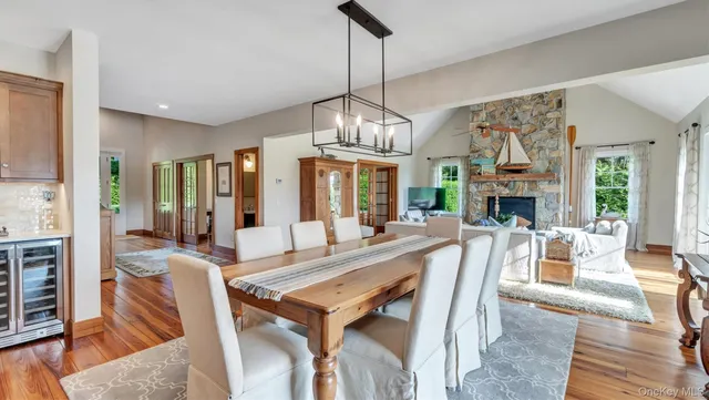 a view of a dining room with furniture wooden floor and chandelier