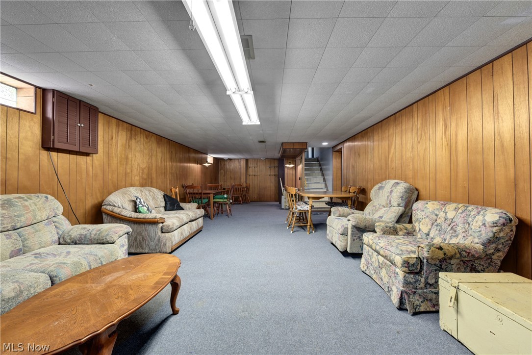 13617 Sheldon Road Cleveland, OH 44130 - Photo 21 of 36 Living room featuring wood walls and carpet flooring