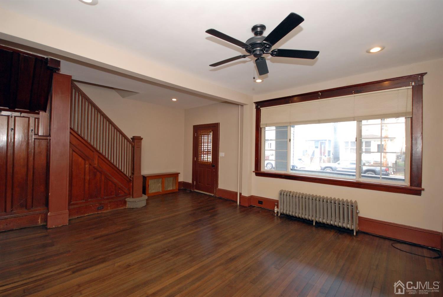 a view of a livingroom with a ceiling fan and window