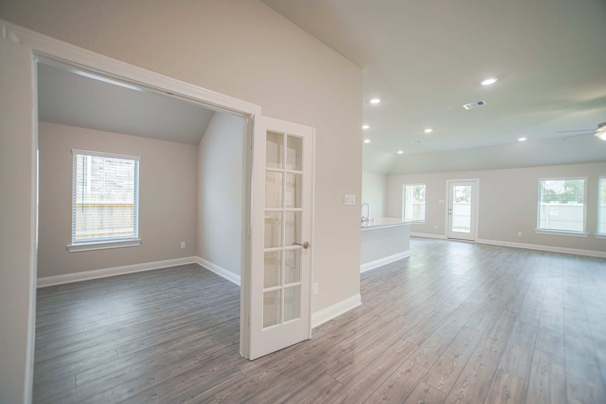 17112 Coneflower Place Conroe, TX 77385 - Photo 4 of 27 an empty room with wooden floor and windows