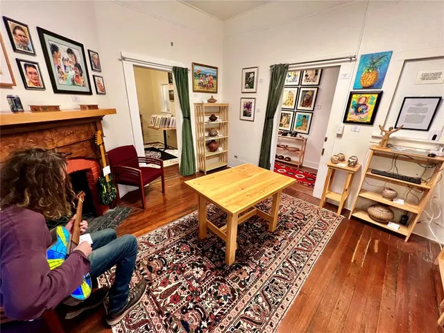 a living room with furniture and wooden floor