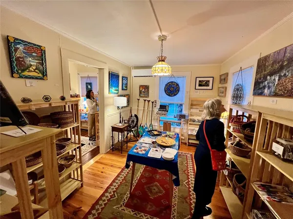 a view of a workspace with furniture and a flat screen tv