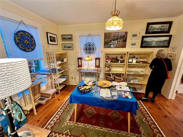 a view of a workspace with furniture and a chandelier