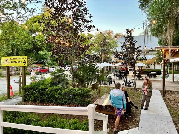 an outdoor space with seating area and trees