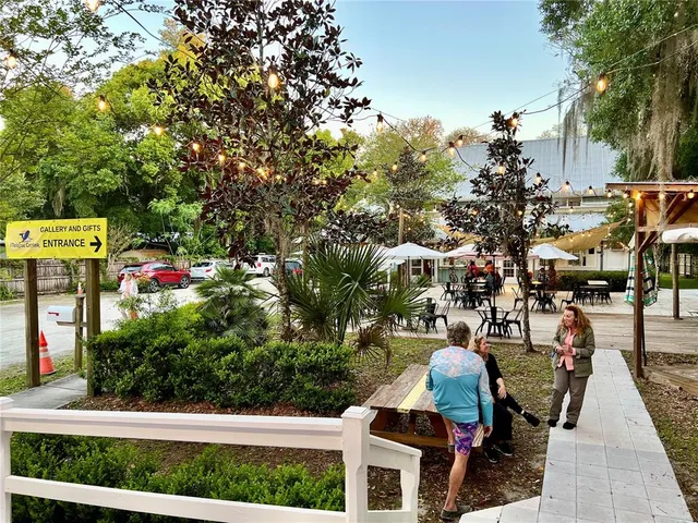 an outdoor space with seating area and trees