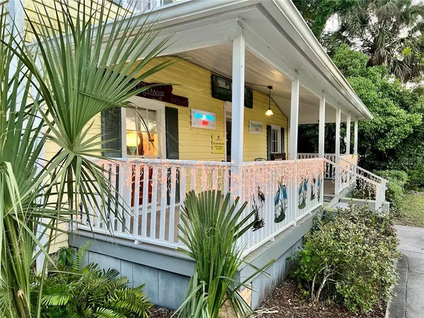 a view of a house with a small yard and plants