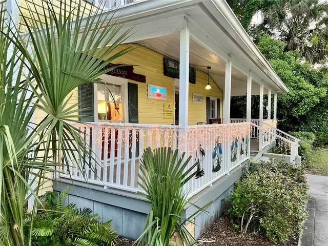 a view of a house with a small yard and plants