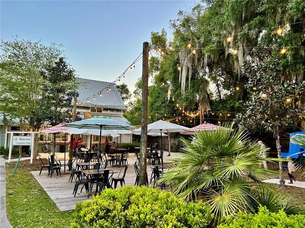 an outdoor space with lots of table and chairs